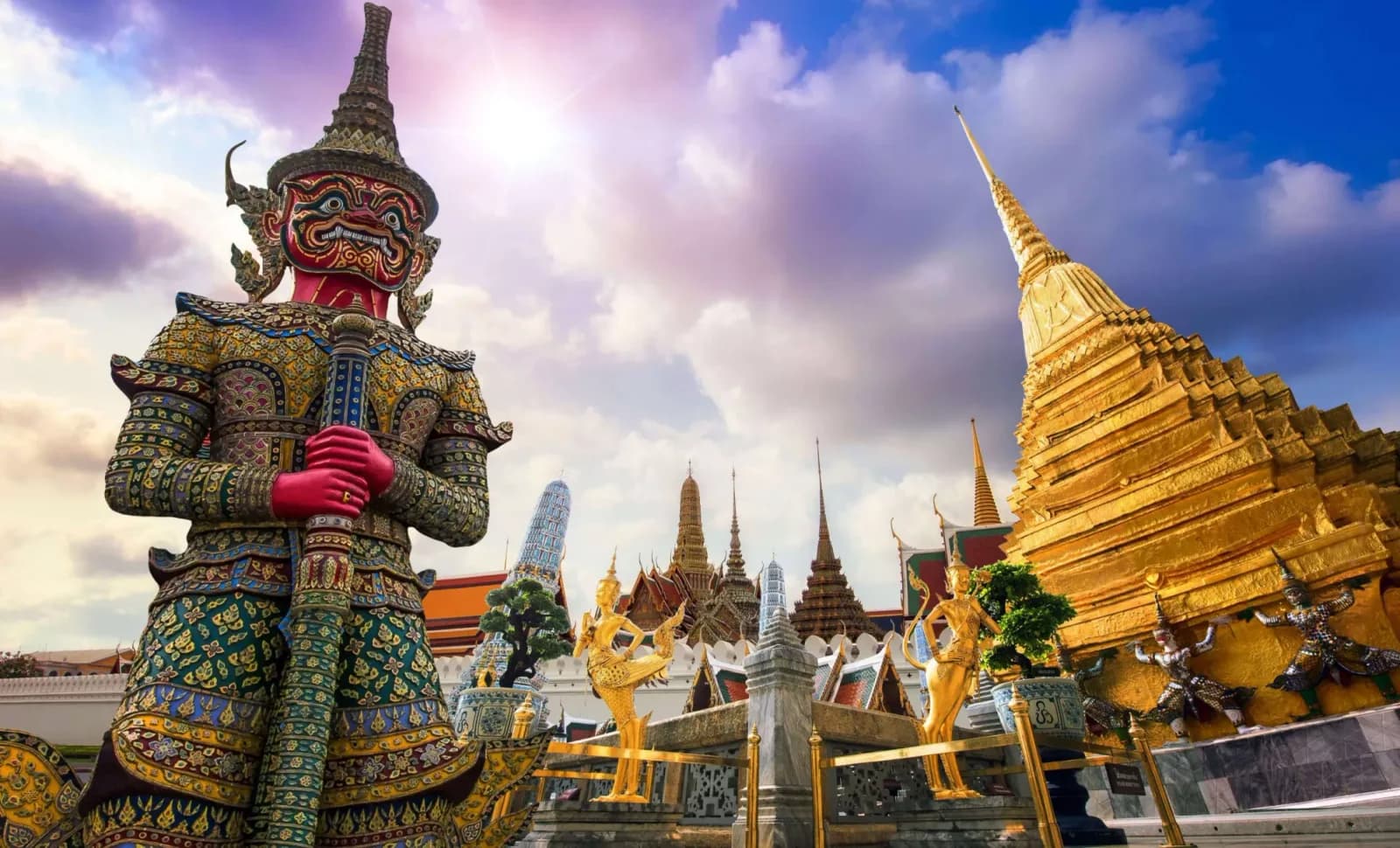 Thailand — gilded chedis of Wat Pho rising above the old city rooftops