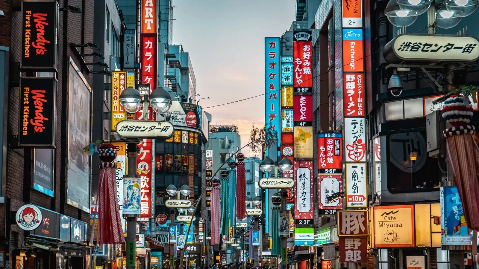 Tokyo — thousands of pedestrians crossing Shibuya's illuminated scramble at night